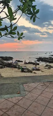 a beach with people on the sand and the ocean at Mamatel boutique in Kamala Beach