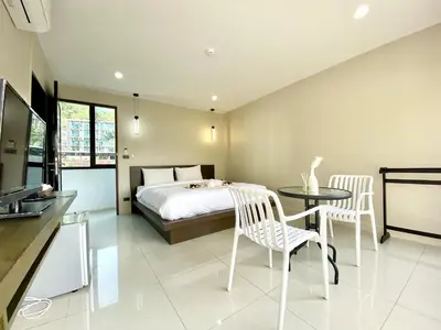 a bedroom with a bed and a table and chairs at Mamatel boutique in Kamala Beach