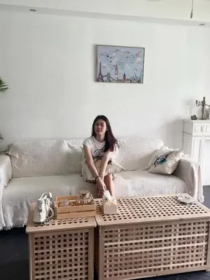 a woman sitting on a couch in a living room at Patong Beach Side Hotel in Patong Beach