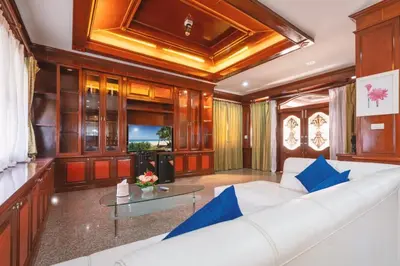 a living room with a white couch and a glass table at The Phuket Pool Villa in Phuket Town