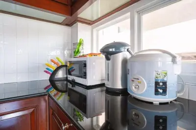 a kitchen counter with a mixer and a microwave at The Phuket Pool Villa in Phuket Town