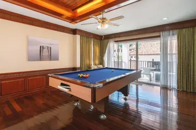 a pool table in a room with a ceiling at The Phuket Pool Villa in Phuket Town
