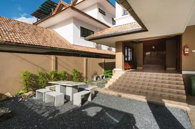 a house with a picnic table in front of it at The Phuket Pool Villa in Phuket Town