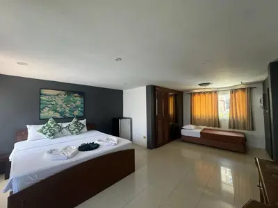 a bedroom with a large bed and a large window at Patong Sea U in Patong Beach