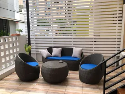 a balcony with two chairs and a table and chairs at Patong Sea U in Patong Beach