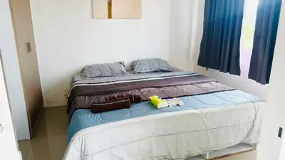 a bed in a room with two twin beds at Phuket naka Condon-41\u65e0\u8fb9\u6cf3\u6c60\u514d\u8d39\u4e0a\u7f51\u514d\u8d39\u505c\u8f66\u4f4d in Phuket Town