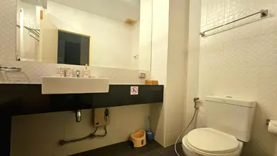a bathroom with a white toilet and a sink at Апартаменты с видом на море на Карон Бич А 509 in Karon Beach