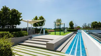 a swimming pool with stairs and a playground at Апартаменты в Лагуне SkyPark c видом на гольф поле in Bang Tao Beach