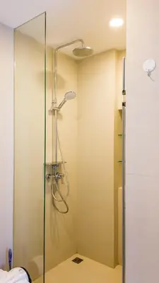 a shower with a glass door in a bathroom at Апартаменты в Лагуне SkyPark c видом на гольф поле in Bang Tao Beach