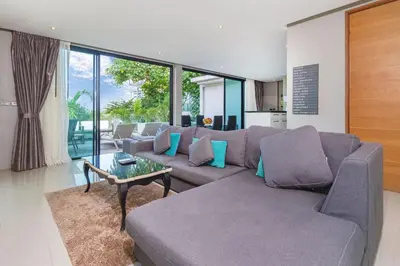 a living room with a couch and a table at Villa Natural Touch A3 in Kamala Beach