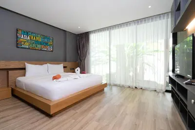 a bedroom with a large bed and a television at Villa Natural Touch A3 in Kamala Beach