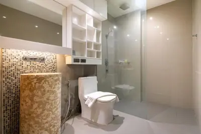 a bathroom with a toilet and a glass shower at Villa Natural Touch A3 in Kamala Beach