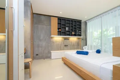 a bedroom with a large bed and a large window at Villa Natural Touch A3 in Kamala Beach