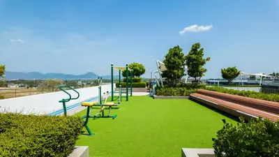 a playground with green grass next to a skate park at Апартаменты в Laguna SkyPark in Phuket Town