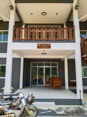 a motorcycle parked in front of a house at Thanid House in Ban Nai Khlong