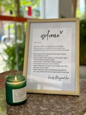 a candle sitting next to a sign with a poem at Issara Patong Beach in Patong Beach