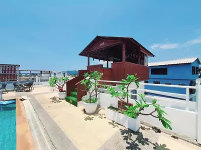 a resort with a pool and a building with plants at Issara Patong Beach in Patong Beach