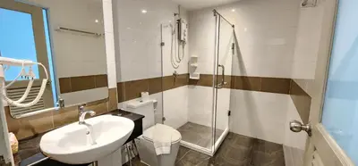 a bathroom with a toilet and a sink and a shower at Issara Patong Beach in Patong Beach