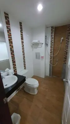 a bathroom with a toilet and a sink and a shower at \u6c34\u679c\u5929\u5802\u65c5\u9986Fruit Paradise in Patong Beach