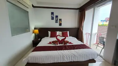 a bedroom with a bed with a heart decoration on it at \u6c34\u679c\u5929\u5802\u65c5\u9986Fruit Paradise in Patong Beach
