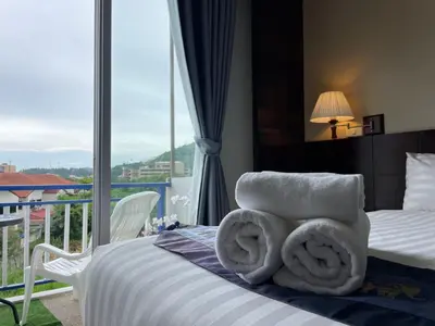 a hotel room with a bed with towels on it at Kata Sea Blue in Kata Beach