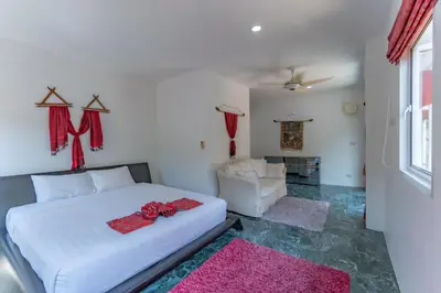 a bedroom with a white bed and a pink rug at Villa Nap Dau private pool villa for big Family and Friends in Ban Klang