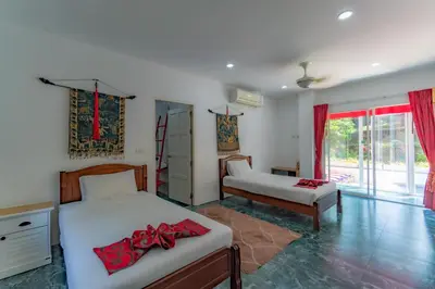 a bedroom with two beds and a window at Villa Nap Dau private pool villa for big Family and Friends in Ban Klang