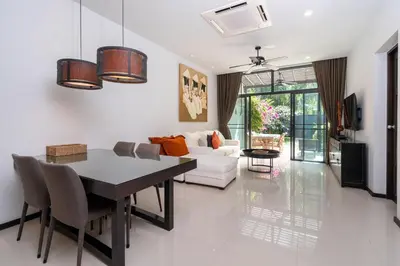 a living room with a table and a couch at Your Private Paradise - 2BR Tropical Pool Villa Astree in Rawai Beach