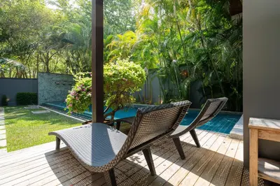 a patio with two chairs and a table and a pool at Your Private Paradise - 2BR Tropical Pool Villa Astree in Rawai Beach