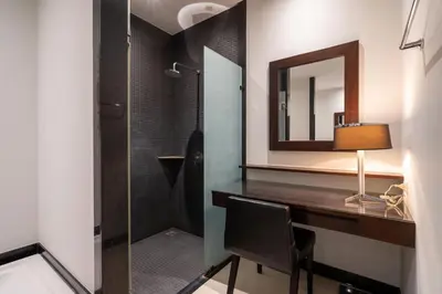 a bathroom with a desk with a mirror and a shower at Your Private Paradise - 2BR Tropical Pool Villa Astree in Rawai Beach