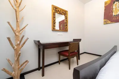 a desk in a room with a bed and a mirror at Your Private Paradise - 2BR Tropical Pool Villa Astree in Rawai Beach