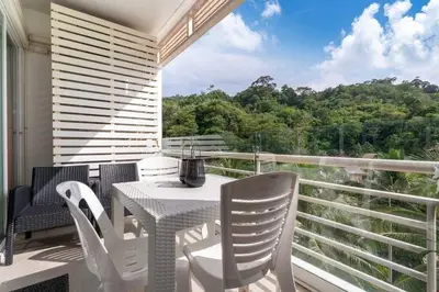 a white table and chairs on a balcony with a view at Royal Kamala - Peaceful Private Rooftop Pool Apartment in Kamala in Kamala Beach