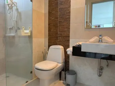 a bathroom with a toilet and a sink and a mirror at Royal Kamala - Peaceful Private Rooftop Pool Apartment in Kamala in Kamala Beach