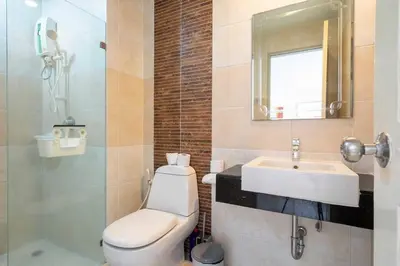 a bathroom with a toilet and a sink and a mirror at Royal Kamala - Peaceful Private Rooftop Pool Apartment in Kamala in Kamala Beach