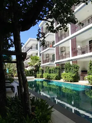 a swimming pool in front of a building at The Title Rawai West Wing Pool View Suite in Rawai Beach