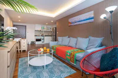 a living room with a couch and a table at The Title Rawai West Wing Pool View Suite in Rawai Beach