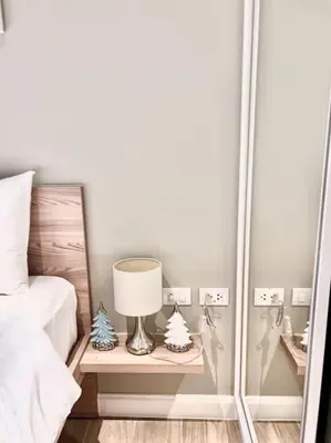a lamp on a night stand next to a bed at Diamond Apartments Phuket Bangtao in Phuket Town