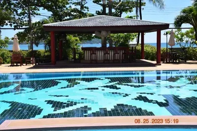a swimming pool in front of a gazebo at kalim residence 217 vue partielle mer in Patong Beach