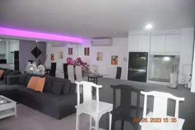 a living room and a kitchen with a couch and a table at kalim residence 217 vue partielle mer in Patong Beach