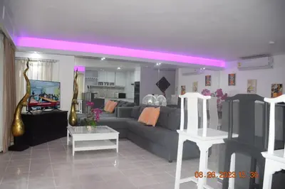 a living room with a gray couch and a tv at kalim residence 217 vue partielle mer in Patong Beach