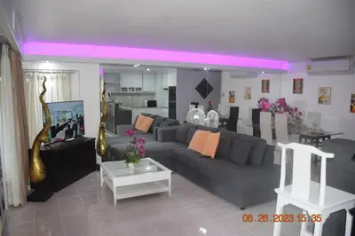 a living room with a gray couch and a table at kalim residence 217 vue partielle mer in Patong Beach