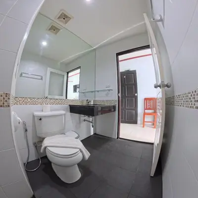 a bathroom with a toilet and a sink and a mirror at Hotel premier in Patong Beach