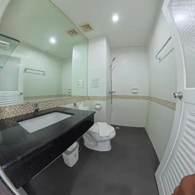 a bathroom with a sink and a toilet and a mirror at Hotel premier in Patong Beach