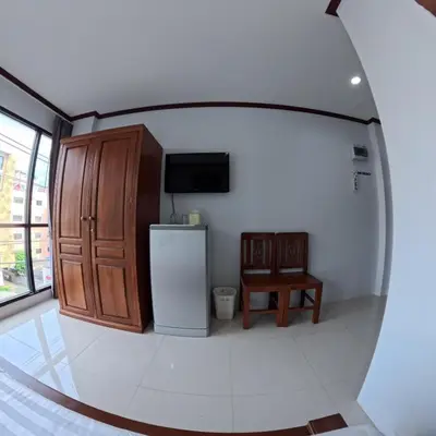 a kitchen with a refrigerator and a table in a room at Hotel premier in Patong Beach