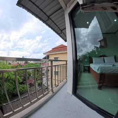 a balcony with a view of a bed on a balcony at Hotel premier in Patong Beach