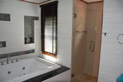 a bathroom with a bath tub and a shower at VILLA SIRINTHARA in Rawai Beach