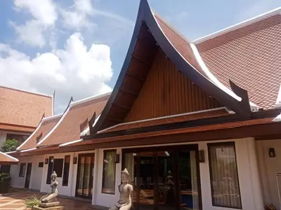 a building with a roof with statues in front of it at VILLA SIRINTHARA in Rawai Beach