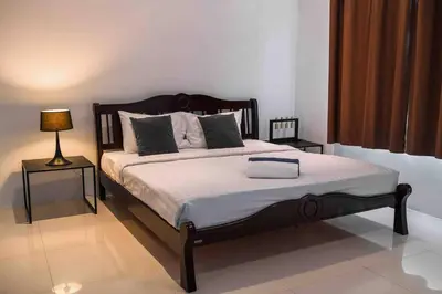 a bedroom with a large bed with two night stands at Large Penthouse 3BR with jacuzzi, Best for Kids in Karon Beach