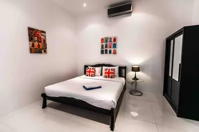 a bedroom with a bed with a book on it at Large Penthouse 3BR with jacuzzi, Best for Kids in Karon Beach