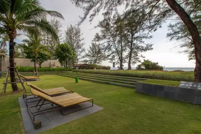 a park with a bench and a swing at Baan Mai Khao by Villacarte in Mai Khao Beach